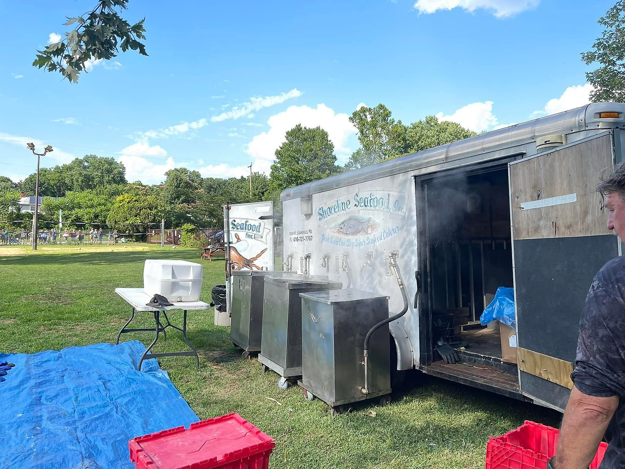 The Shoreline Seafood trailer open on site with the steamers running
