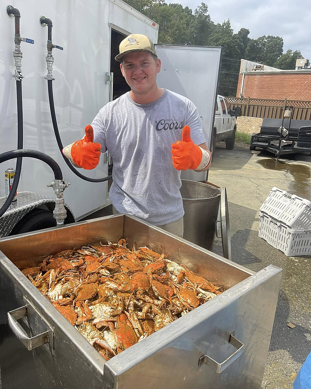 Shoreline Seafood crew with a tray of hot steamed crabs